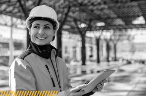 Female construction worker holding clipboard